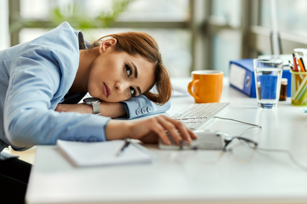 pensive businesswoman feeling bored resting her office desk